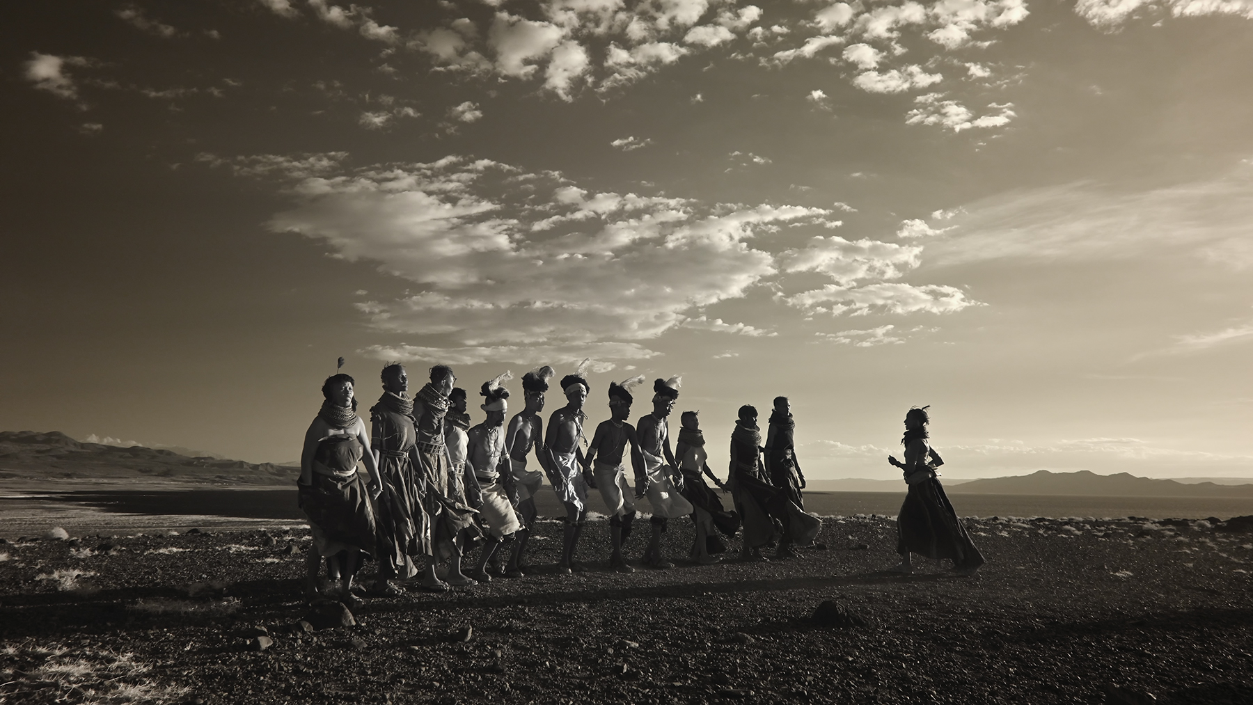 Fine art print of the Turkana tribe dancing in the landscape of Lake Turkana, Kenya